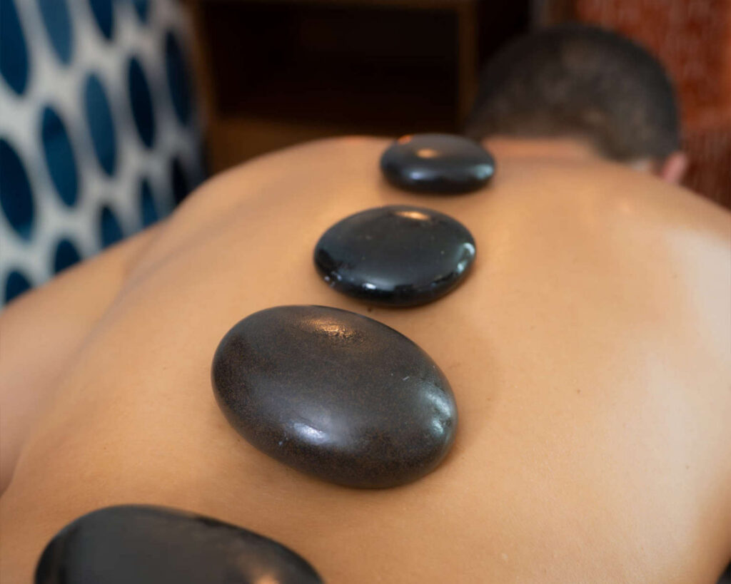 Man receiving a hot stone massage.