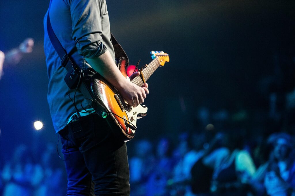 Guitarist facing the crowd at a concert.